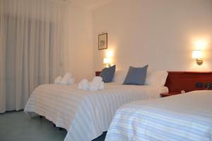 Postel nebo postele na pokoji v ubytování Tafuri Hotel