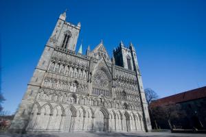 a large cathedral with a blue sky in the background at Thon Hotel Trondheim in Trondheim