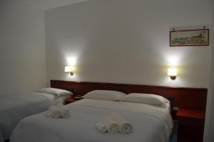 Postel nebo postele na pokoji v ubytování Tafuri Hotel