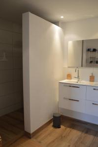 a white kitchen with a sink and a counter at Appartement Bellevue du Ventoux in Montbrun-les-Bains
