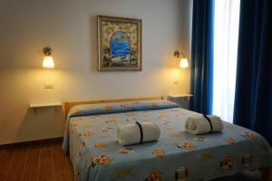 a bedroom with a bed with two pillows on it at La Casa di Aurelio in Capo dʼOrlando