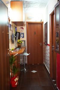 a hallway with a desk and a door in a room at Golden Dreams Reggio Calabria in Reggio di Calabria