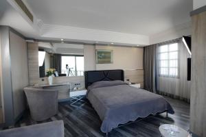 Säng eller sängar i ett rum på Hotel Marla