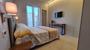 Postel nebo postele na pokoji v ubytování B&B La Piazzetta
