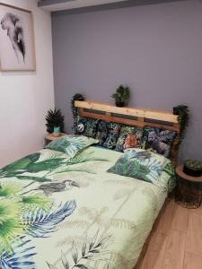 La Roche-BlancheLe Menhir 2 Jacuzzi Spa Terasse Barbecue的卧室里有一张带木质床头板的床