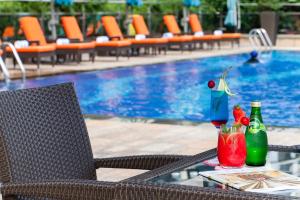 a table with two drinks on it next to a pool at Fraser Suites Guangzhou in Guangzhou