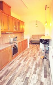 a kitchen with wooden cabinets and a table in it at maison de campagne in La Celle-Saint-Cyr