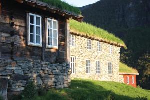 a stone building with a grass roof on a hill at Vassbakken in Skjolden