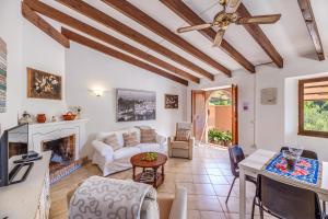 a living room with a couch and a fireplace at Ca n'aina in Cala Tuent