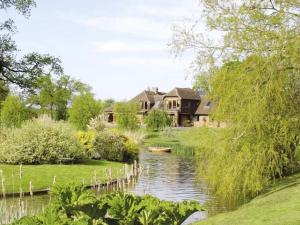 a house by a river with a house at Northlands Farm - Old Farm Cottage in Chichester