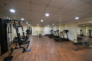 a gym with several treadmills and elliptical machines at KeyHost - Frankfurt 1307 in Dubai