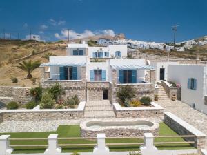 a villa with a staircase in front of a house at Οasis Apartments in Amorgos