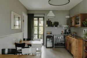 a kitchen and dining room with a table and chairs at Villa Antiqua in Racibórz