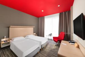 A bed or beds in a room at Park Inn By Radisson Budapest