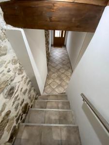 a staircase in a house with a stone wall at The Little Caravia in Caravia