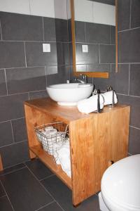 a bathroom with a sink and a toilet at Quinta do Malhinha- Turismo in Angra do Heroísmo