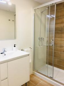 a bathroom with a sink and a shower at Aiguaneu El Celler in Blanes +11 photos
