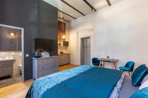 - une chambre avec un lit bleu et une salle de bains dans l'établissement Loft Apartments Leipzig Loft Aqua, à Leipzig