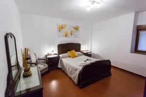 a bedroom with a bed with a yellow pillow on it at CASA SEGADE in A Coruña