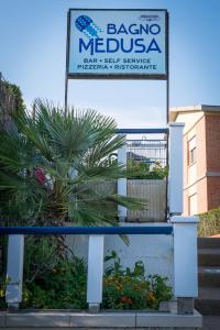 a sign for a baracoa mexican restaurant at Hotel Perla in Castiglione della Pescaia