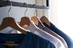 a row of shirts are hanging on a rack at Hotel Perla in Castiglione della Pescaia
