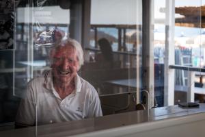 an older man sitting in front of a window at Hotel Perla in Castiglione della Pescaia