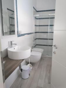 a white bathroom with a sink and a toilet at Elite Boutique Hotel in Roseto degli Abruzzi
