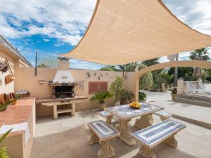 an outdoor patio with a table and a grill at Holiday Home Ca Na Guerrera by Interhome in Crestatx