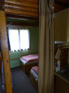 a bedroom with two bunk beds and a window at Chatky Apollo na Vysočině in Nové Město na Moravě