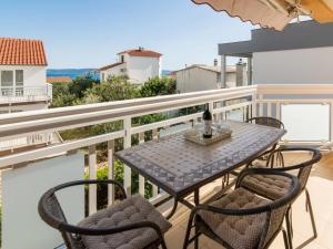 a table and chairs on the balcony of a house at Apartment Villa Nikaroni-2 by Interhome in Trogir