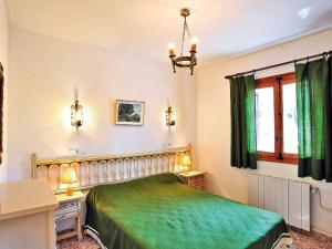 a bedroom with a green bed and a desk at Holiday Home Flova by Interhome in Balcon del Mar
