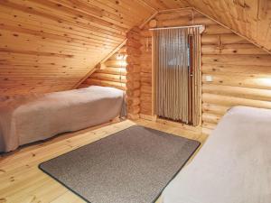 Kuusjärvi的住宿－維庫林偉蘭塔度假屋，小木屋设有两张床和窗户