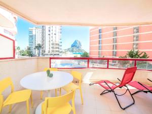 a balcony with a table and chairs in a building at Apartment Amatista-7 by Interhome in Calpe