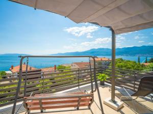 a balcony with a bench and a view of the water at Holiday Home Matea by Interhome in Rijeka