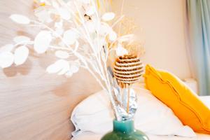 a green vase with a tooth brush in it at Hotel et Appartements Reine D'Azur in Roquebrune-Cap-Martin