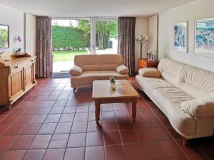 a living room with a couch and a table at Holiday Home Den Osse by Interhome in Brouwershaven