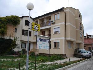 ein Apartmenthaus mit einem Schild davor in der Unterkunft Blue Apartments & Suites in Ohrid