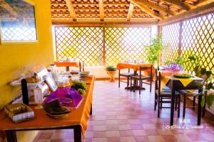 a restaurant with tables and chairs in a room at B&B La Terra di Parmenide in Ascea