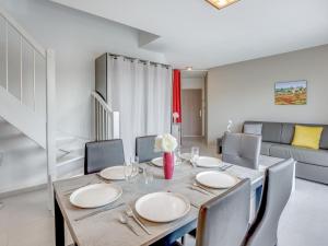 a dining room with a table and chairs at Apartment La Closerie des Tremieres by Interhome in Saint-Georges-de-Didonne
