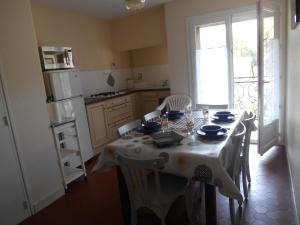 a kitchen with a table with a white table cloth at Appartement Vallée de Luchon in Salles-et-Pratviel