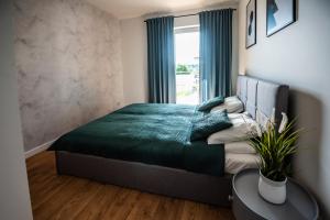 Кровать или кровати в номере Marina Lake Iława