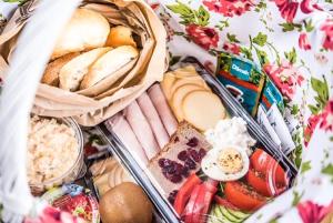 a picnic basket filled with different types of food at Apartamenty Pod Tatrzańskim Niebem in Zakopane