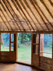 an empty room with a wooden ceiling and windows at Purling Brook Falls Gwongorella in Springbrook