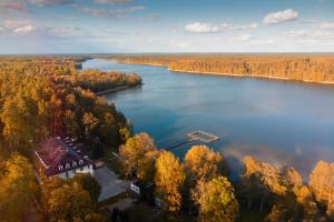 an aerial view of a river with trees and a house at Ośrodek Gawra in Nidzica