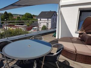 a balcony with a table and chairs and a table at Apartment near Frankfurt, fantastic view! in Usingen