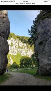 une vue d'une montagne entre deux gros rochers dans l'établissement Nasza Polana Pokoje Noclegi Pieskowa Skała Ojców, à Pieskowa Skała