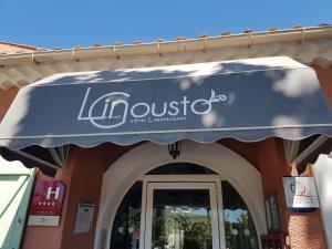 a blue awning over the entrance to a building at Le Mas du Lingousto in Cuers