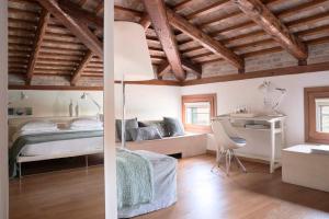 a bedroom with a bed and a desk in a room at Venissa Wine Resort in Burano