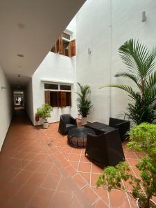 a courtyard with furniture and plants in a building at Heeren Straits Hotel in Malacca