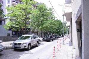 a row of cars parked on the side of a street at Apartment Central-LUX in Veliko Tŭrnovo